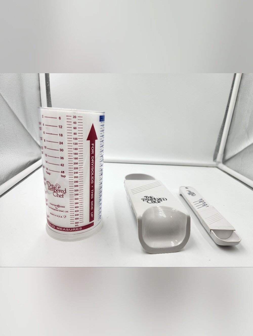 3 Pampered Chef measuring cups. A Measure All 2 Cup,a 1/2 Cup scoop, Tablespoon